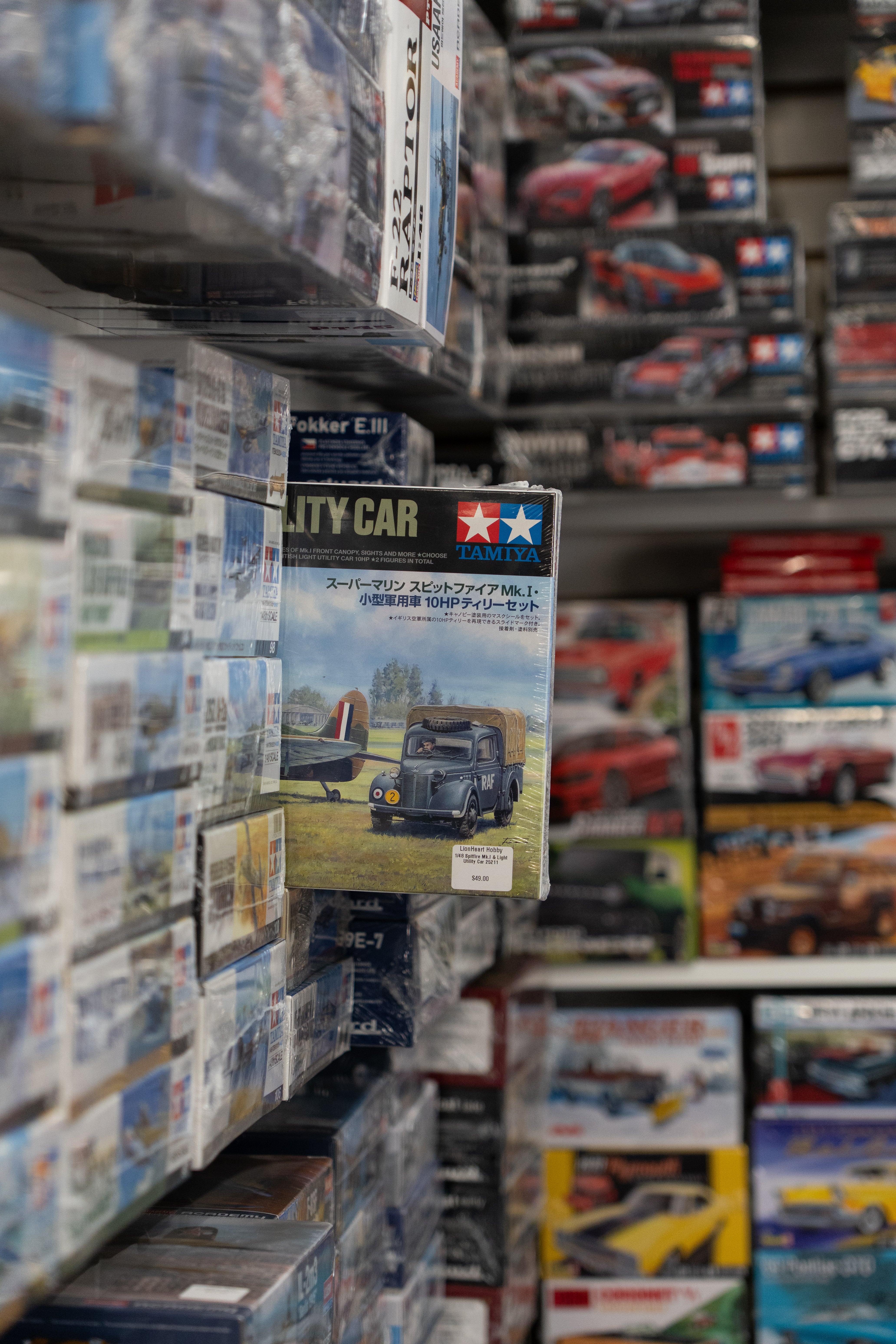 Display of model car boxes with Tamiya branding in a store setting
